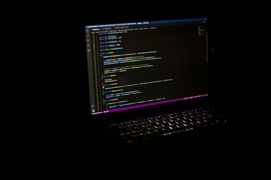programmer coding on laptop