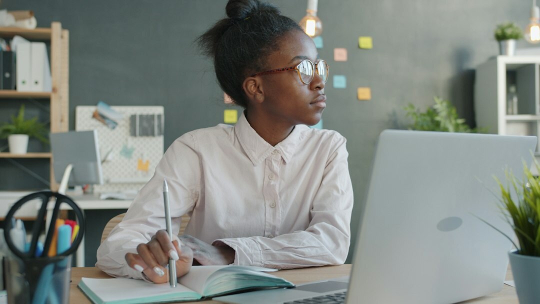 woman writing code at desk