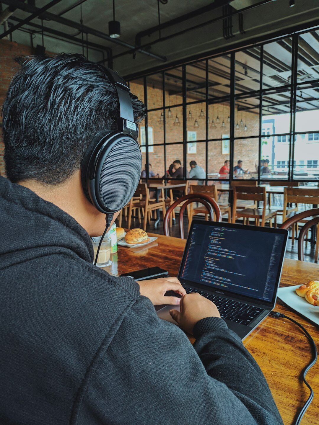 programmer coding on laptop