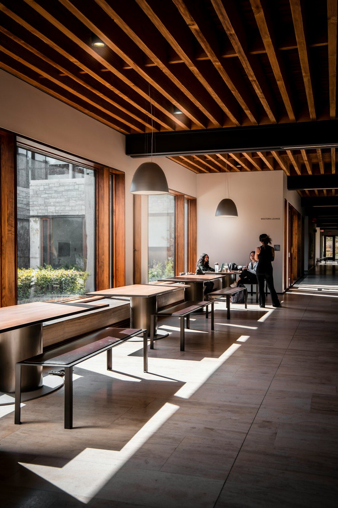 Modern open-plan office with people working on laptops