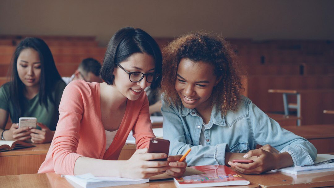 diverse students learning coding in classroom